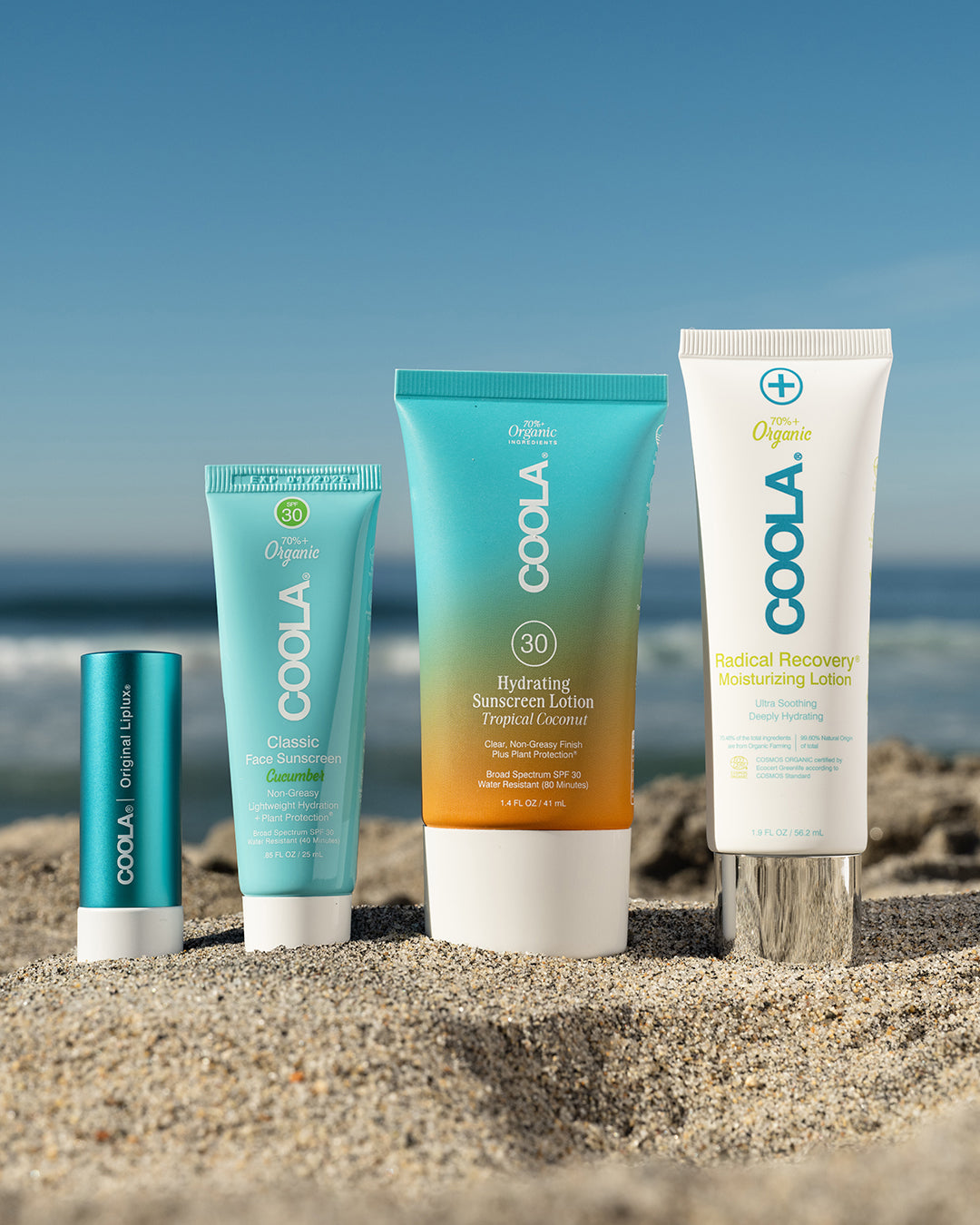 4 COOLA sunscreen products in sand
